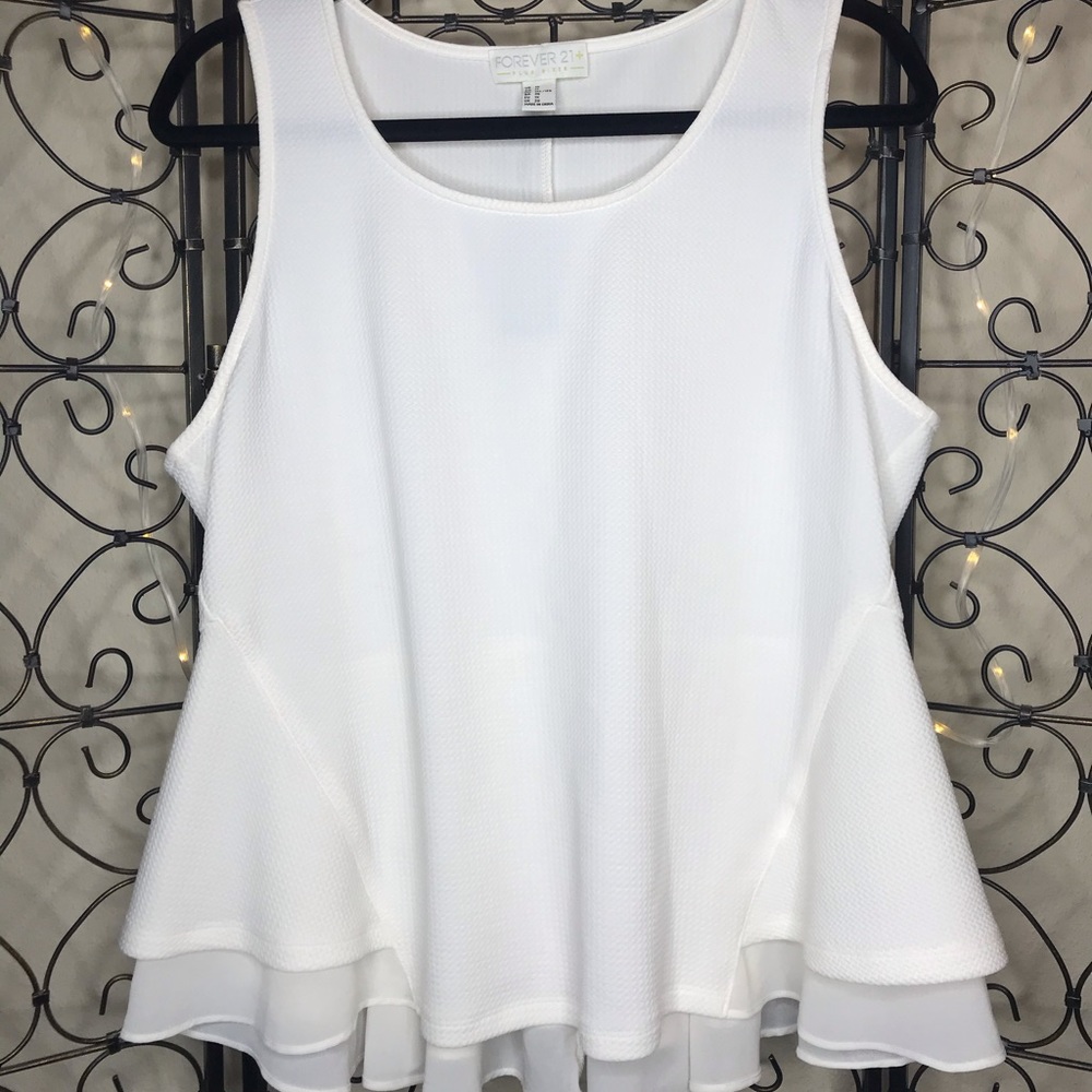 Delicate peplum top with sheer detailing